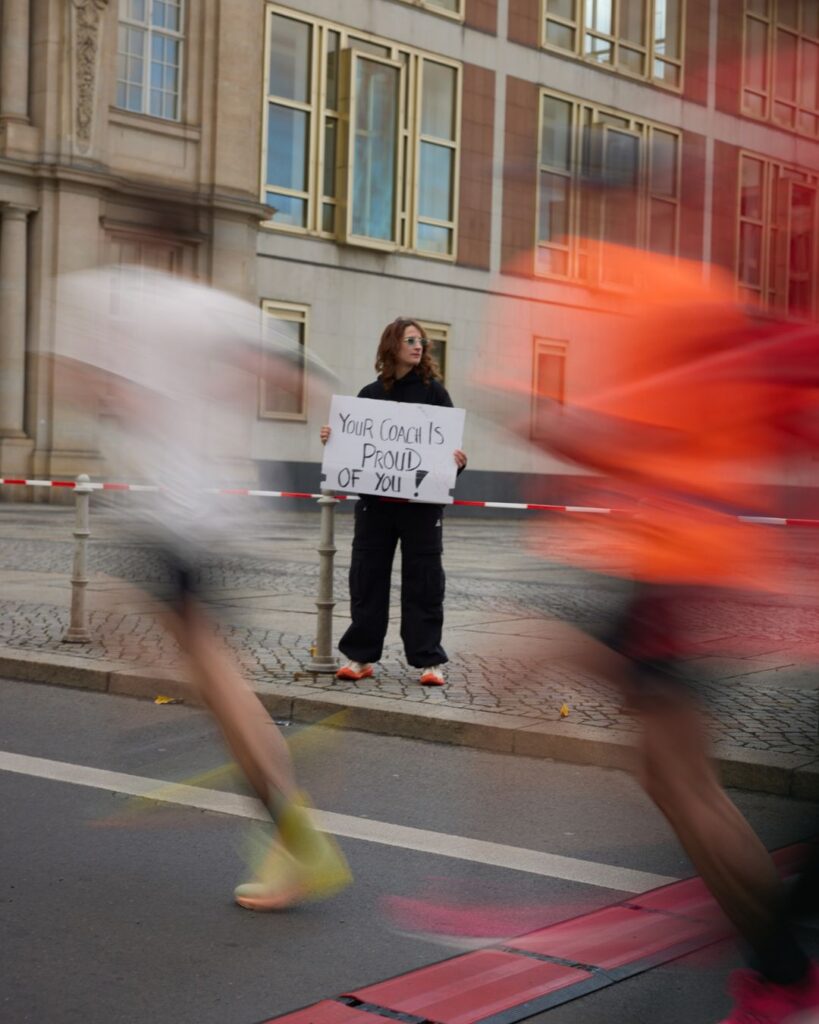Bewegungsunschärfe von LäuferInnen in der Stadt, Chrissi steht im Hintergrund.